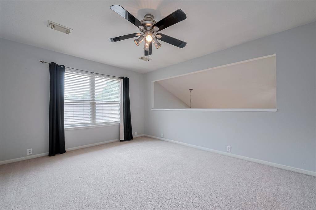 Upstairs game room with large window for plenty of natural light