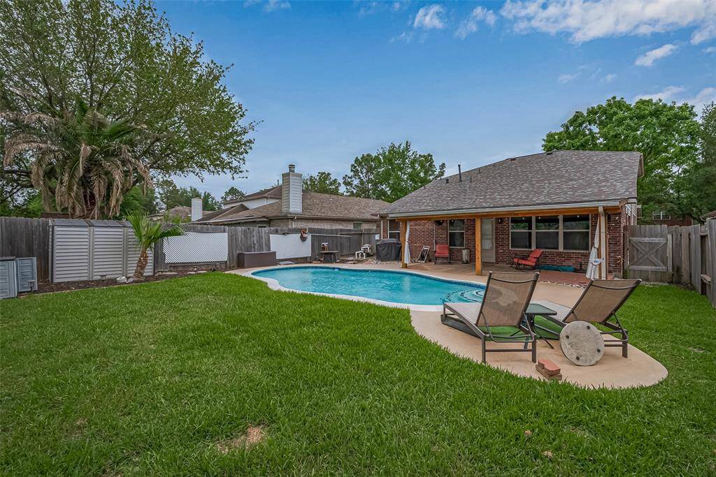 Check out your new outdoor oasis complete with pool and covered patio.