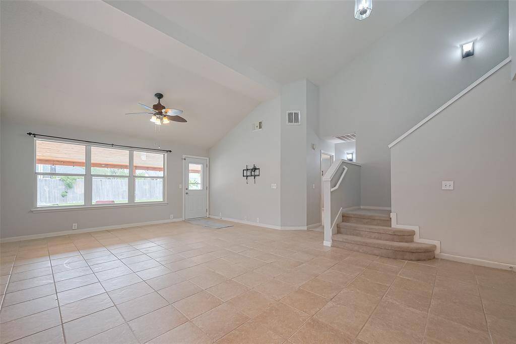 Large living room with soaring ceilings and access to patio!
