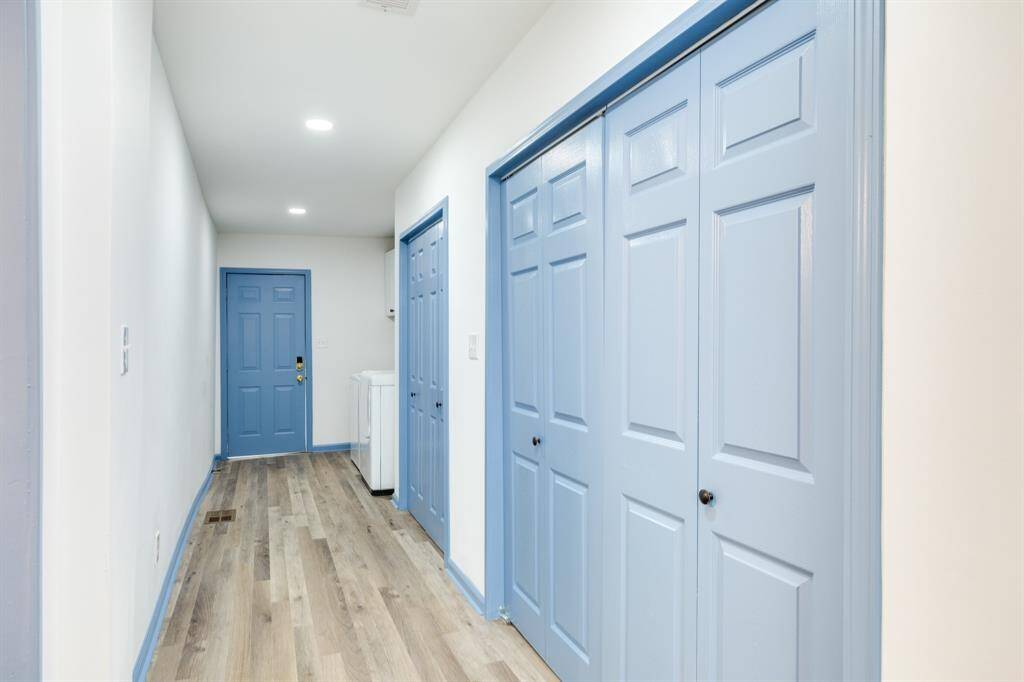 hallway with abundant storage and laundry leading to the back deck in downstairs unit 1