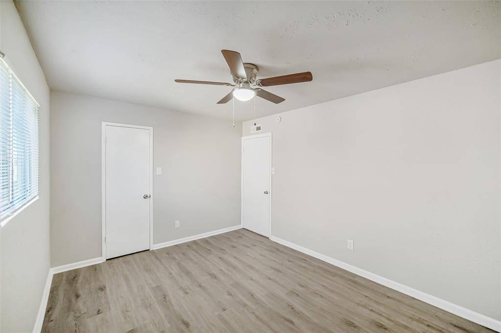 The secondary bedroom features designer-inspired paint and brand-new LVP flooring, adding a fresh and modern touch.