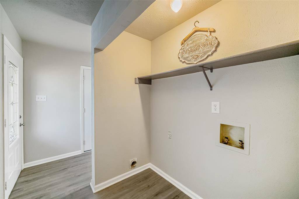 The utility room is conveniently located at the front of the home next to the primary bedroom.