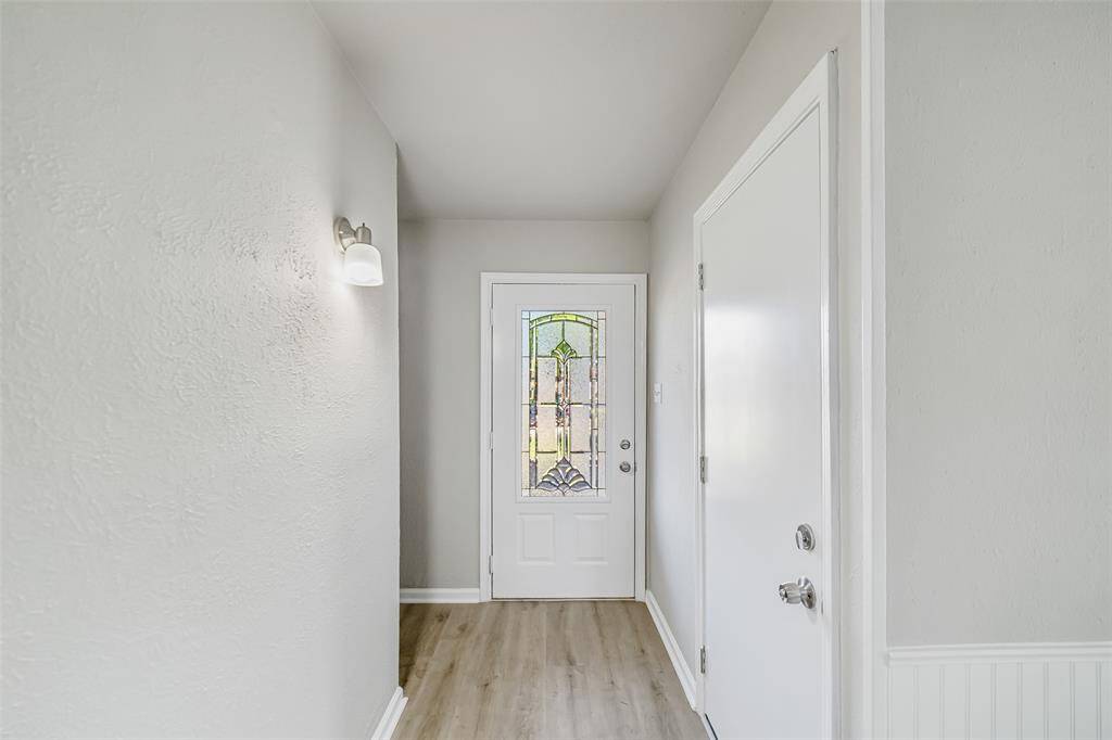 Stepping through the beautifully designed glass-etched front door, you're welcomed by stunning Brand-New LVP flooring, adding elegance and durability to the space.