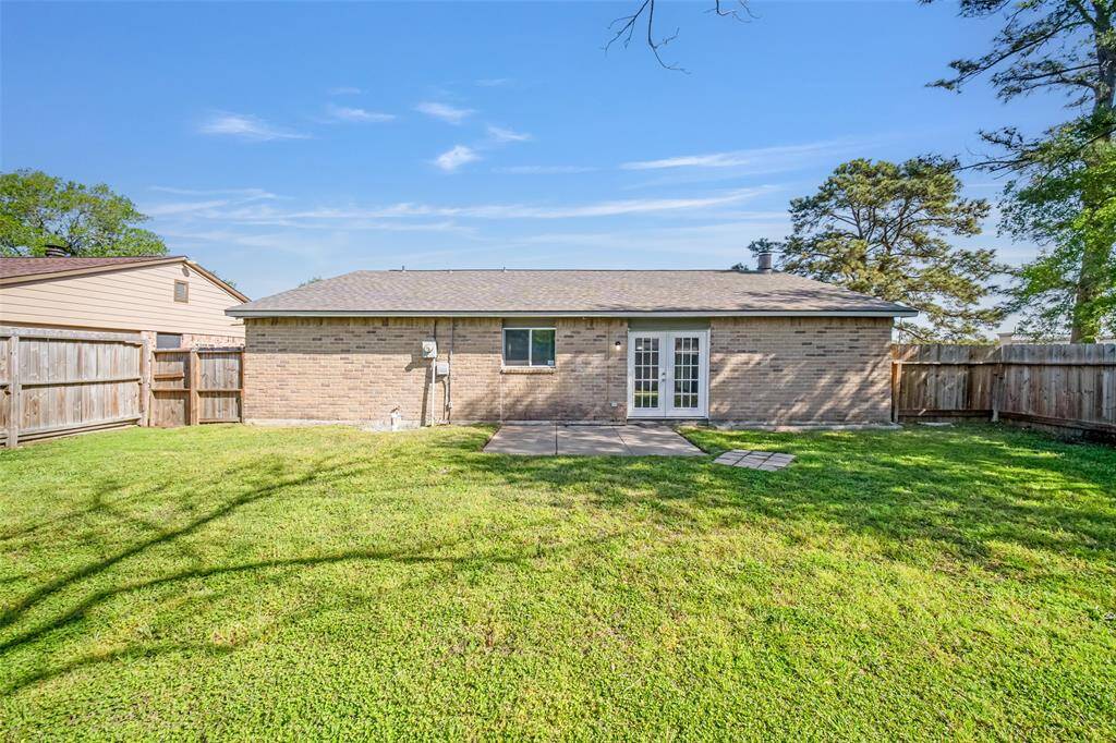 The backyard features a patio and green space for outdoor play or gardening.