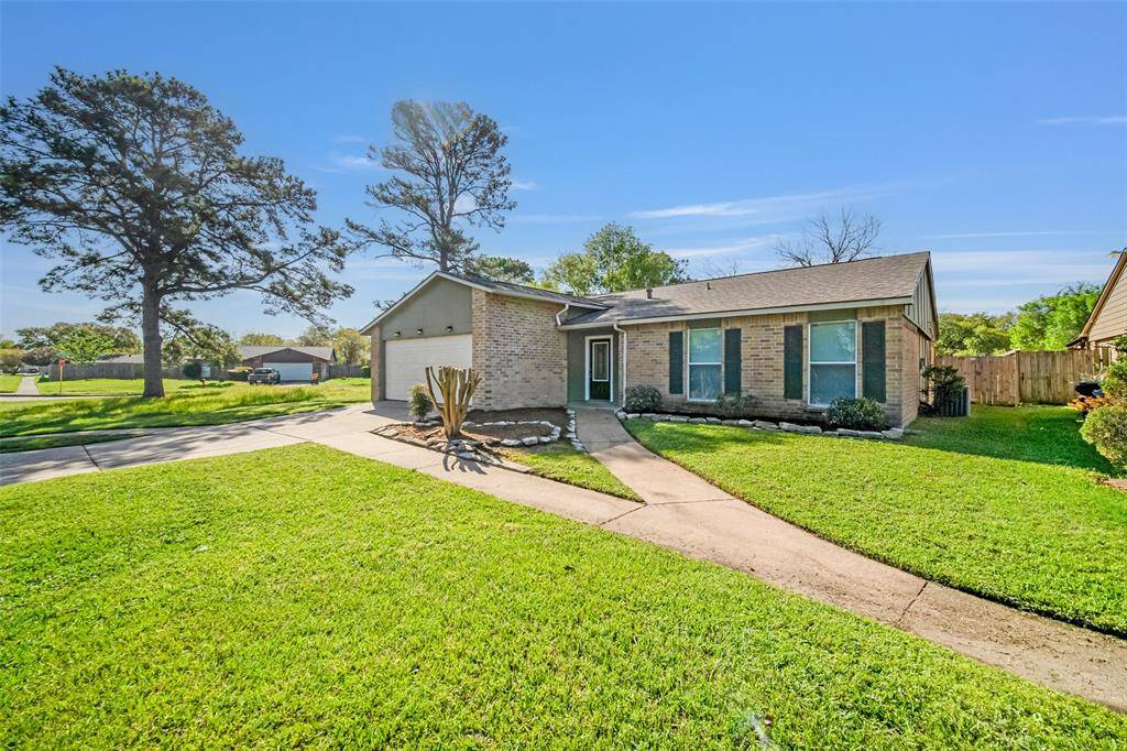 Newly mulched flower beds, along with a power-washed driveway and walk paths, enhance the charm of the home's exterior.