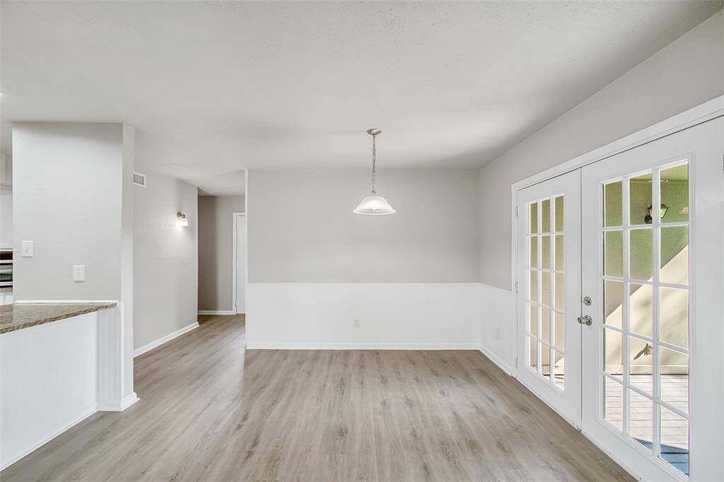 Natural light pours through the windows of the NEW back patio French doors, offering a bright and airy feel to the breakfast room.
