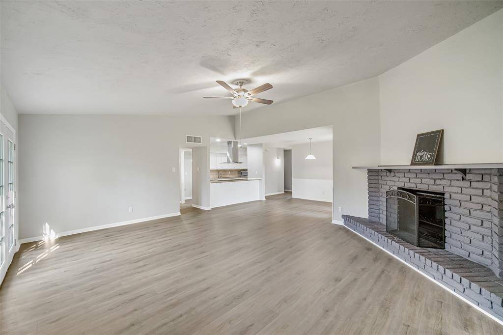 This view from the family room highlights the open layout and seamless flow between the breakfast room and kitchen.