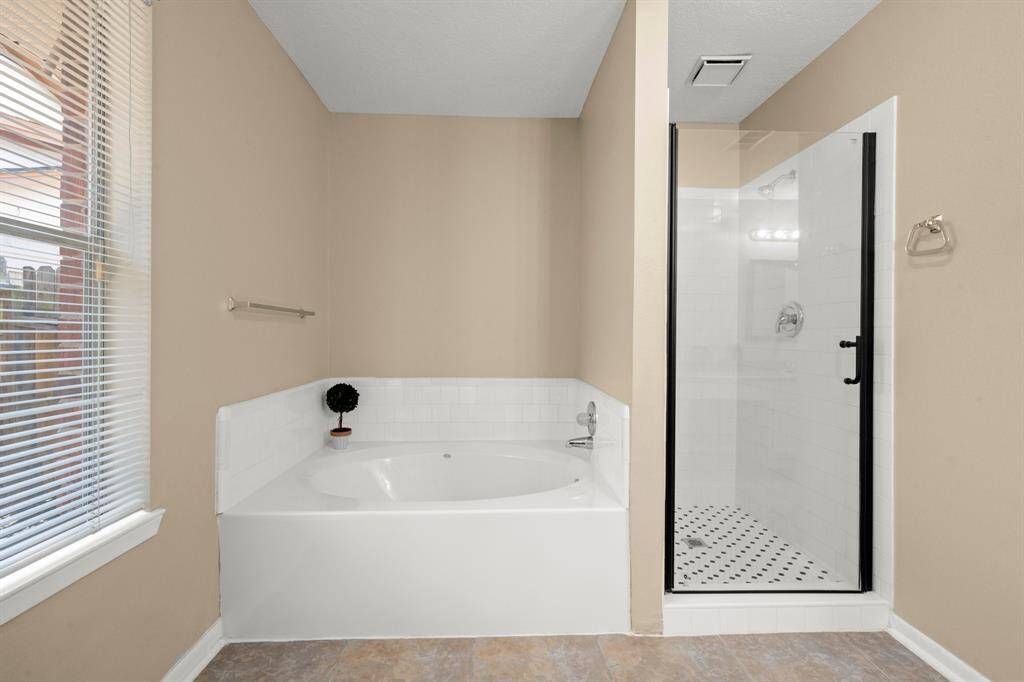 Garden tub and separate shower in the primary suite