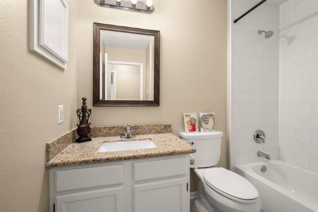 Secondary bath has a shower/tub combo with granite counter tops.