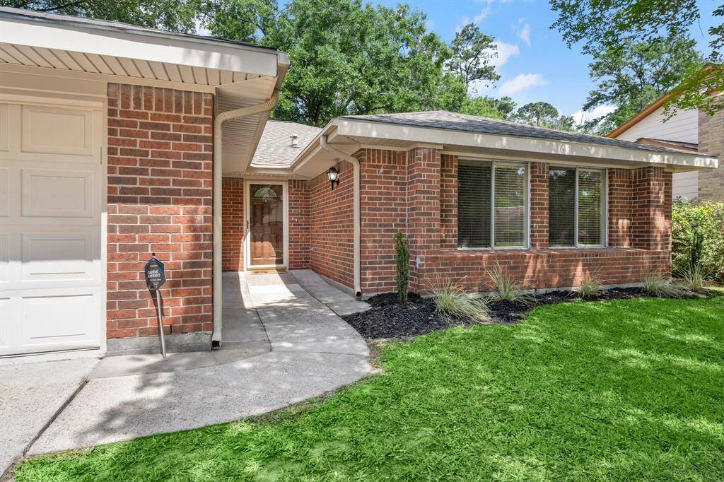 Lovely red brick front elevation. Home has gutter and new landscaping.