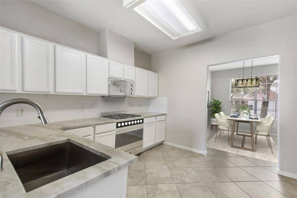 This picture has been Virtually staged. New stainless dishwasher, garbage disposal & under mount stainless sink fixture. The kitchen is open, flows well into the dining and living areas & has lots of natural light.