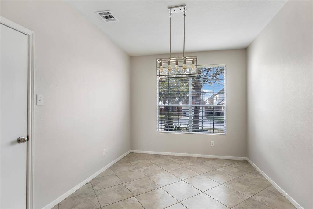 Dining room view with door on the left leading to the 2 car garage.