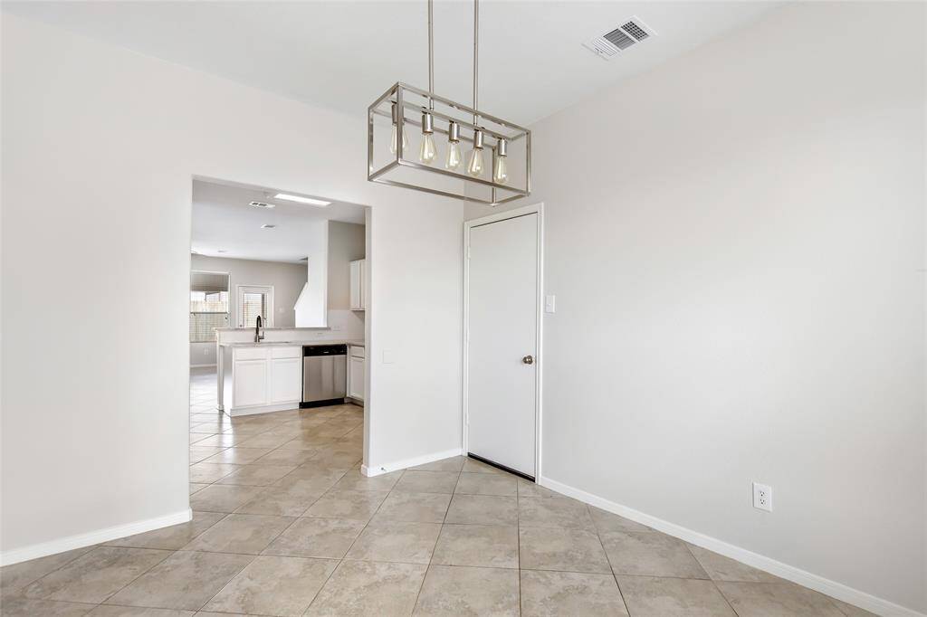 Spacious dining room with easy access from kitchen. New lighting.