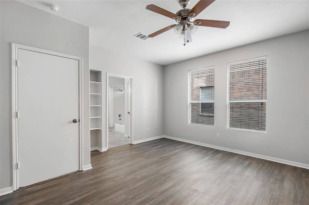 Downstairs Primary Bedroom has Beautiful new wood looking LVP (Luxury Vinyl Plank) flooring is easy to clean and hypoallergenic.
