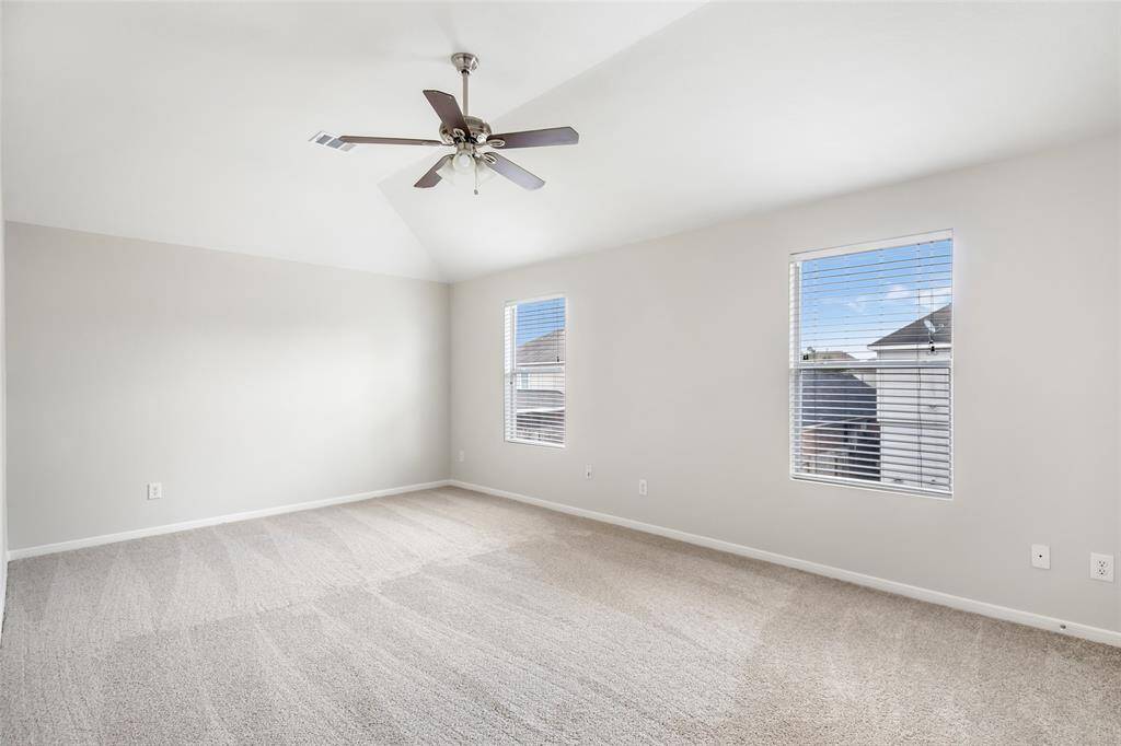 Upstairs Bonus room with new carpet, fresh paint, ceiling fan and 2 inch faux wood blinds.