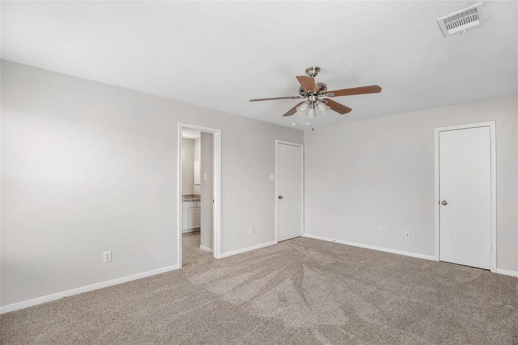 Bedroom with new carpet, fresh paint, ceiling fan and 2 inch faux wood blinds.