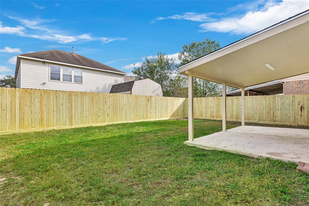 Spacious back yard with new privacy fence.