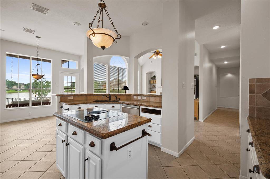 The breakfast room in the distance looks out to the water and pool. The missing kitchen drawer is getting replaced ASAP!
