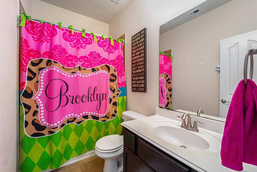 Secondary bathroom offers a combination tub and shower.