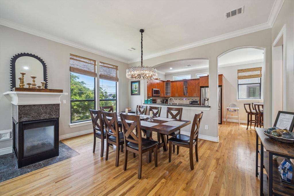 View of dining area with kitchen and breakfast area in the background.