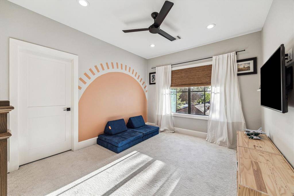 The walk-in shower has stylish hexagonal tiles and a built-in niche with patterned accents and a freestanding tub adds a touch of luxury, while geometric flooring enhances the contemporary feel.