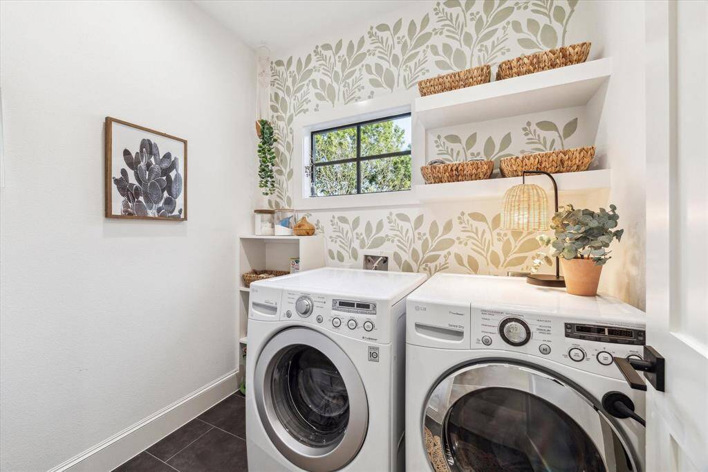 This secondary bedroom features  ample natural light from two large windows and a spacious closet with French door.