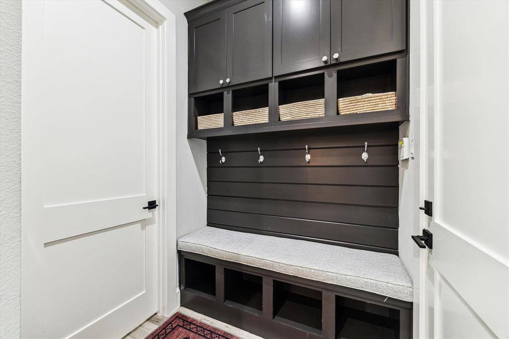 The secondary bathroom features a sleek, white vanity with marble countertops and stylish light fixtures.
