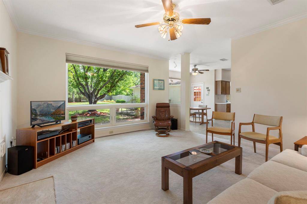 The large Andersen picture window provides abundant natural light as well as beautiful views of the mature trees, grass and spacious back yard.