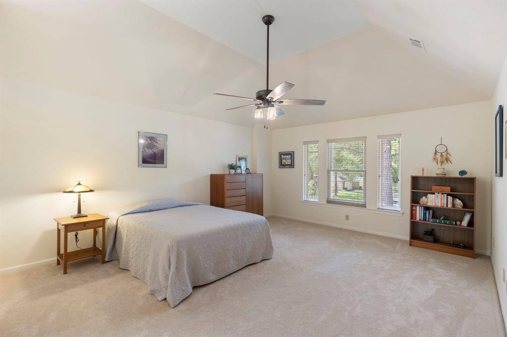 The primary bedroom is extremely spacious with high ceilings and lovely views of mature trees at the front of the home. There is plenty of room for a sitting area creating a primary retreat. Also, you'll appreciate a large walk in closet.
