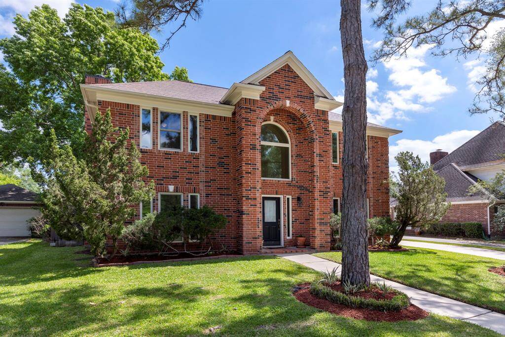 Well manicured front lawn with mature trees greet you as you arrive.