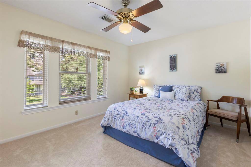 The third bedroom located upstairs is spacious and overlooks the mature trees at the front of the home.