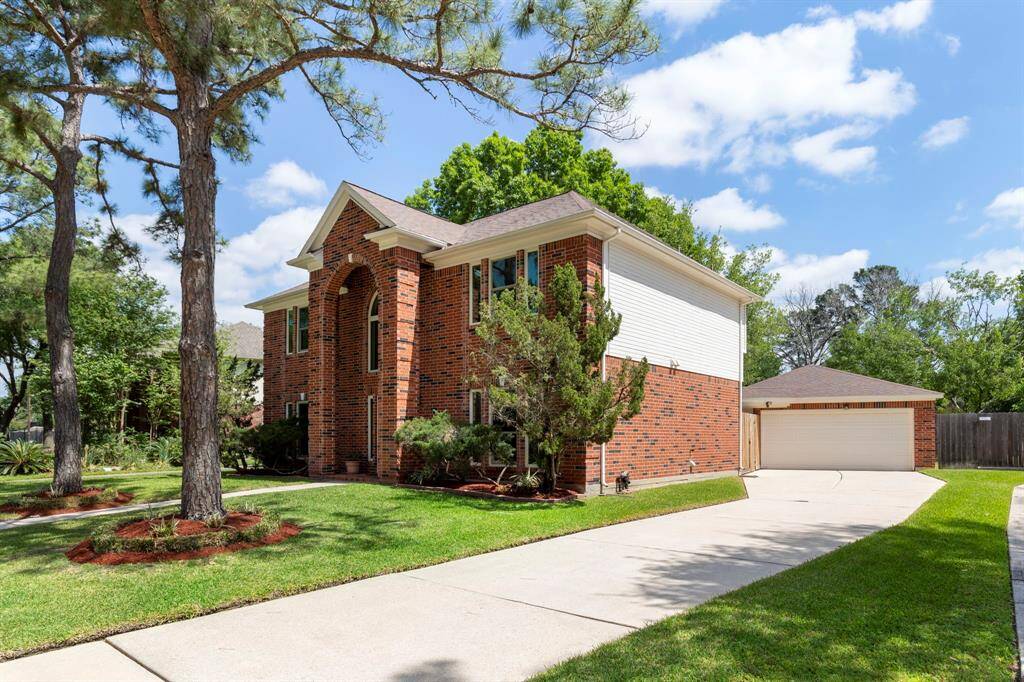 Detached garage allows for plentiful parking in the spacious driveway.