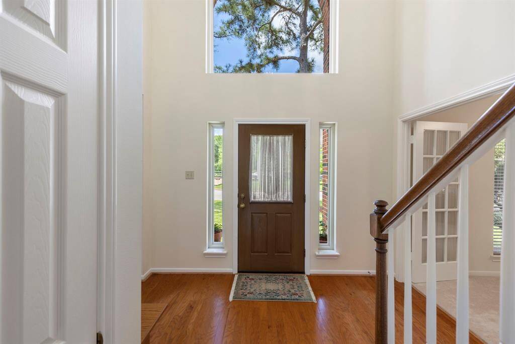 Two story foyer with large window floods the entry with abundant natural light.