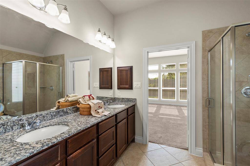 Beautiful Fixtures and Countertops with Cabinets in Primary Bathroom