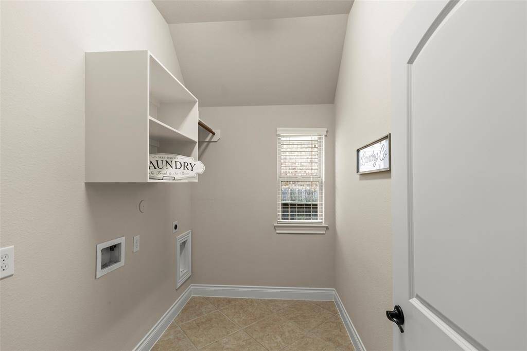 Nice Sized Laundry Room with Shelves and Hanging Rod for Storage