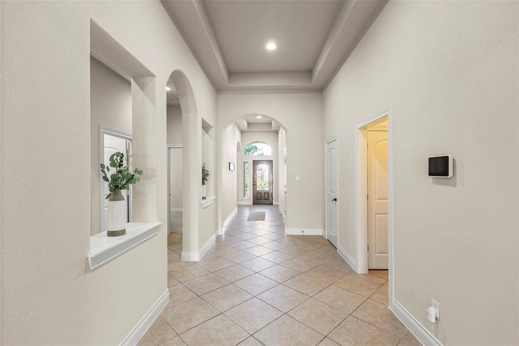 Beautiful Archways and Tile Floors into each Section of the Home