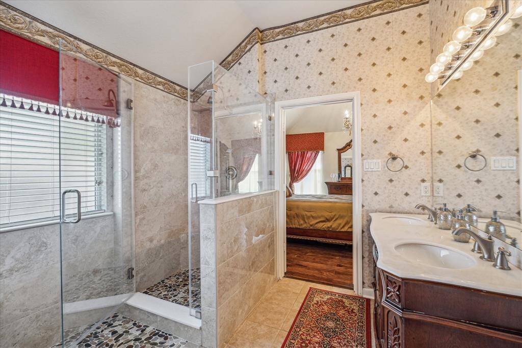 Re-modeled primary bathroom with pebble tile shower floors.