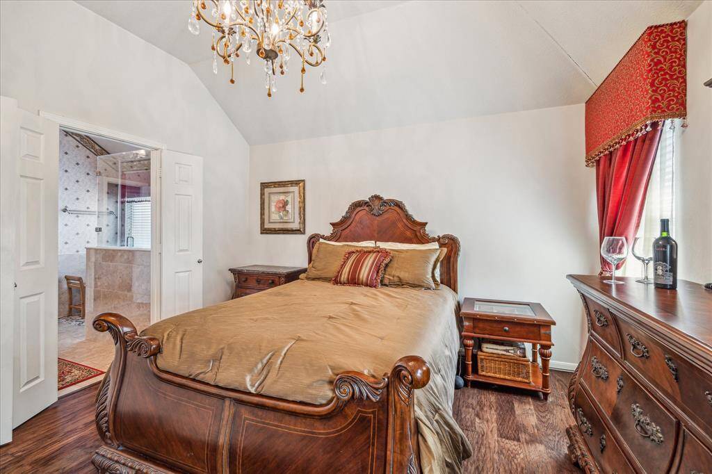 Primary bedroom with engineered wood floors.