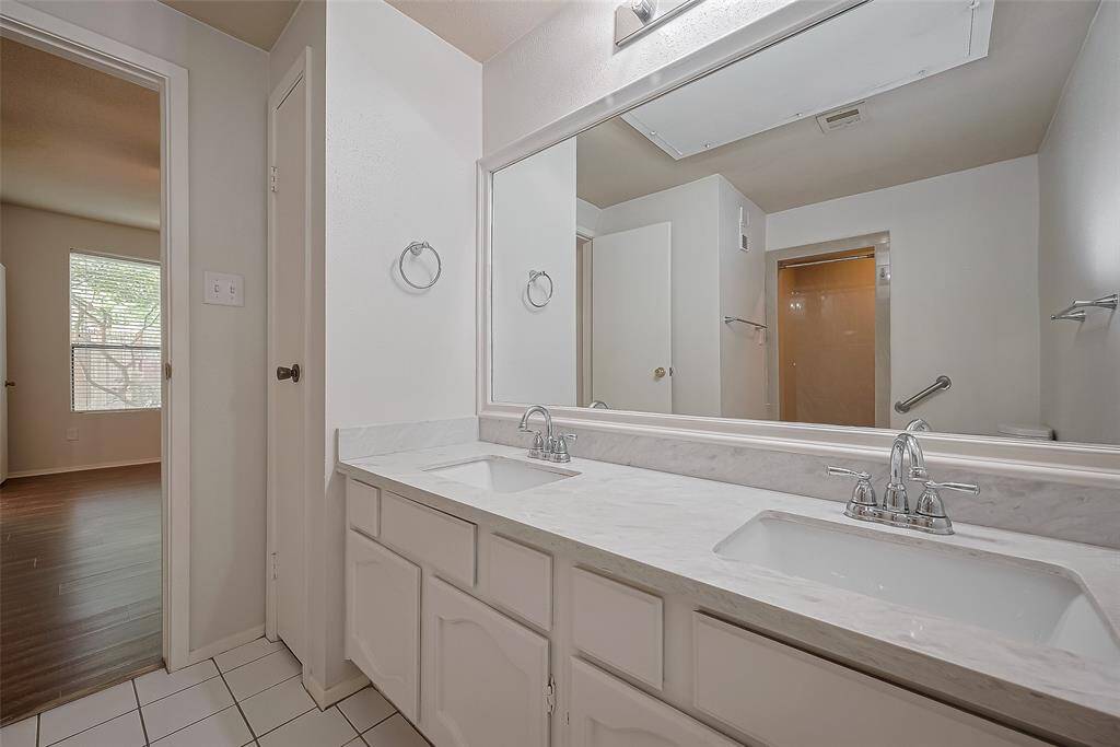 Experience the luxury of a primary bathroom that features a stunning quartz double sink, complemented by a spacious mirror that adds to the elegance of the space. With ample storage options, this bathroom combines style and functionality, making it the perfect retreat for your daily self-care rituals.