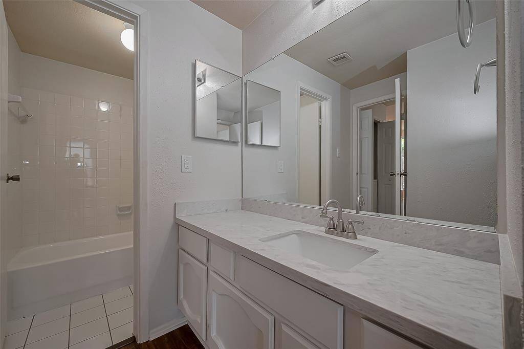 The guest bathroom has been beautifully transformed with sleek quartz countertops and a fresh coat of paint, creating a modern and inviting space for your visitors.