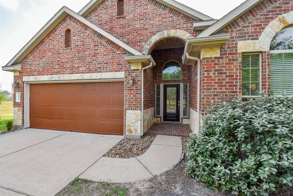 Charming brick exterior with an inviting arched entryway and spacious two-car garage. Perfect blend of elegance and functionality.