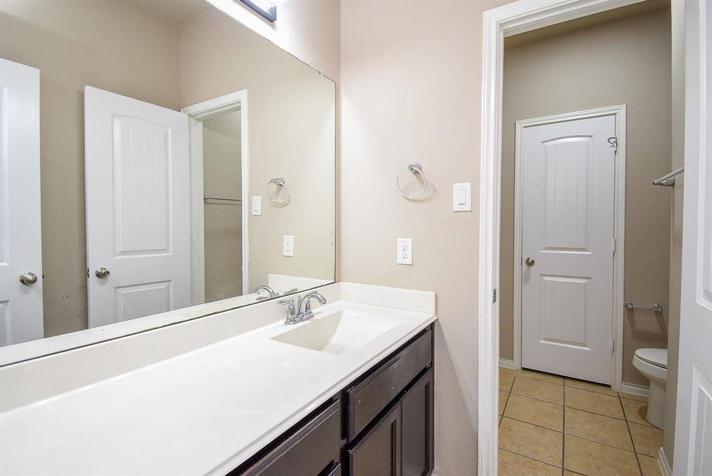 Spacious second full bathroom with modern fixtures.