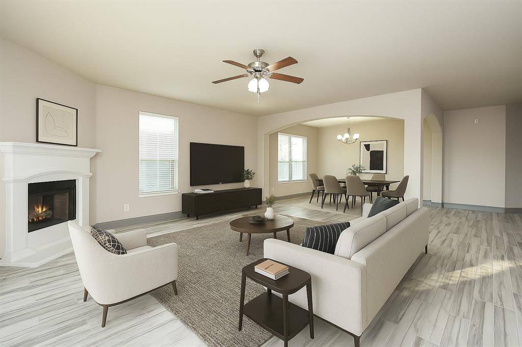 Spacious and inviting open-concept living and dining area, perfect for entertaining and relaxation. Virtual staging was used.