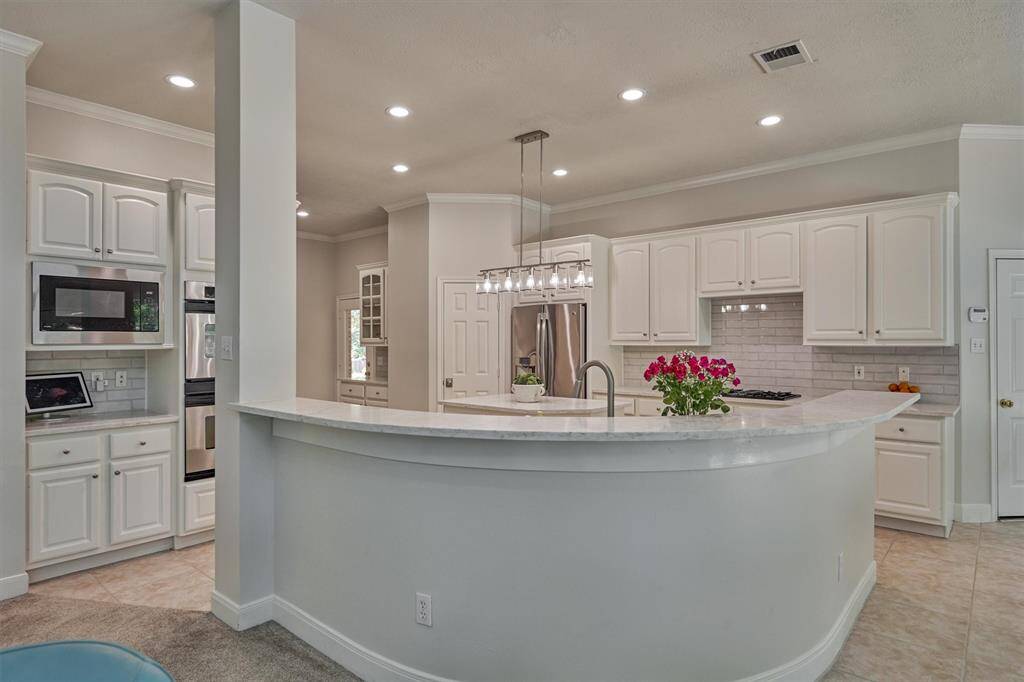 What a view from all angles! Newly remodeled kitchen is magazine-worthy with crisp and clean lines, designer finishes, and sterling views via upgraded double pane windows to a private backyard oasis!