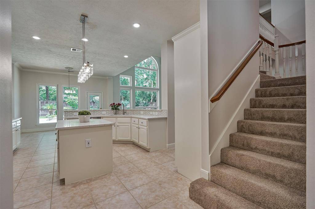 Wide, open spaces for cooking and entertaining in this dreamy kitchen with quartz countertops and panoramic views to a tranquil setting in back! No. Rear. Neighbors!