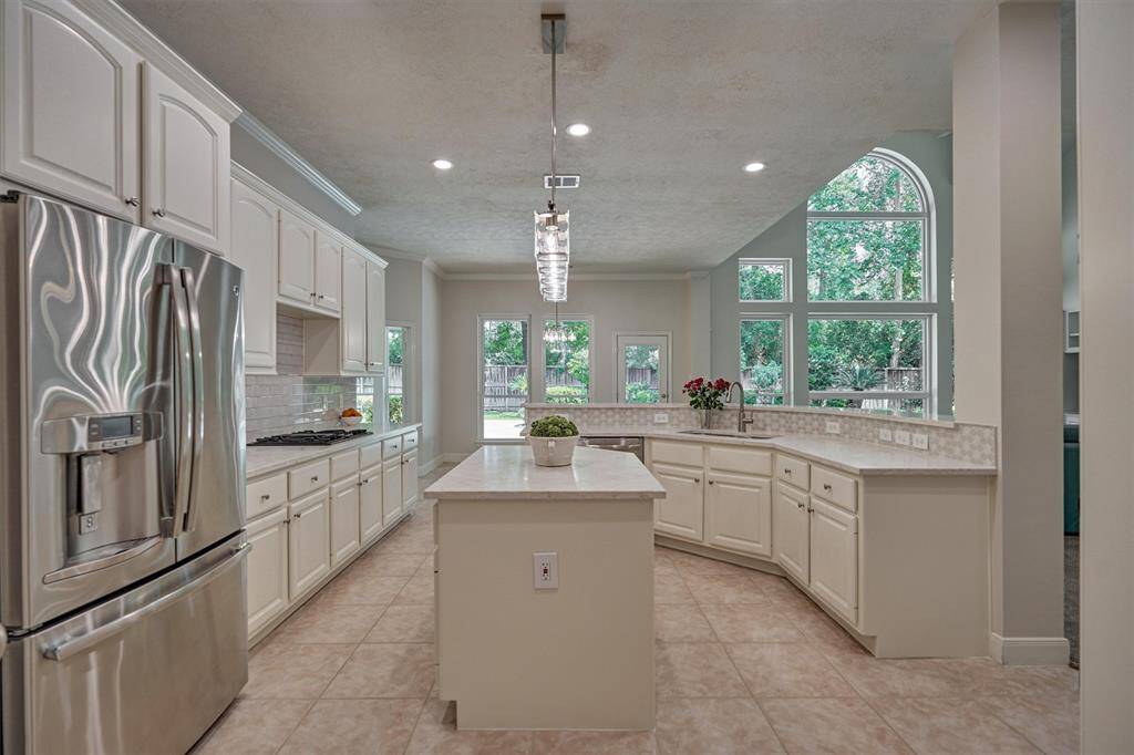 This oversized breakfast room is a perfect gathering area with soothing views to a sparkling pool & spa!
