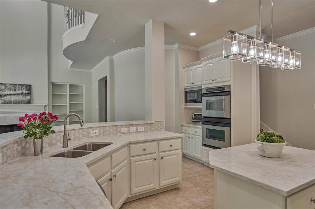 Just off the breakfast room, you'll find the serene sun room wrapped in wall-to-wall windows!