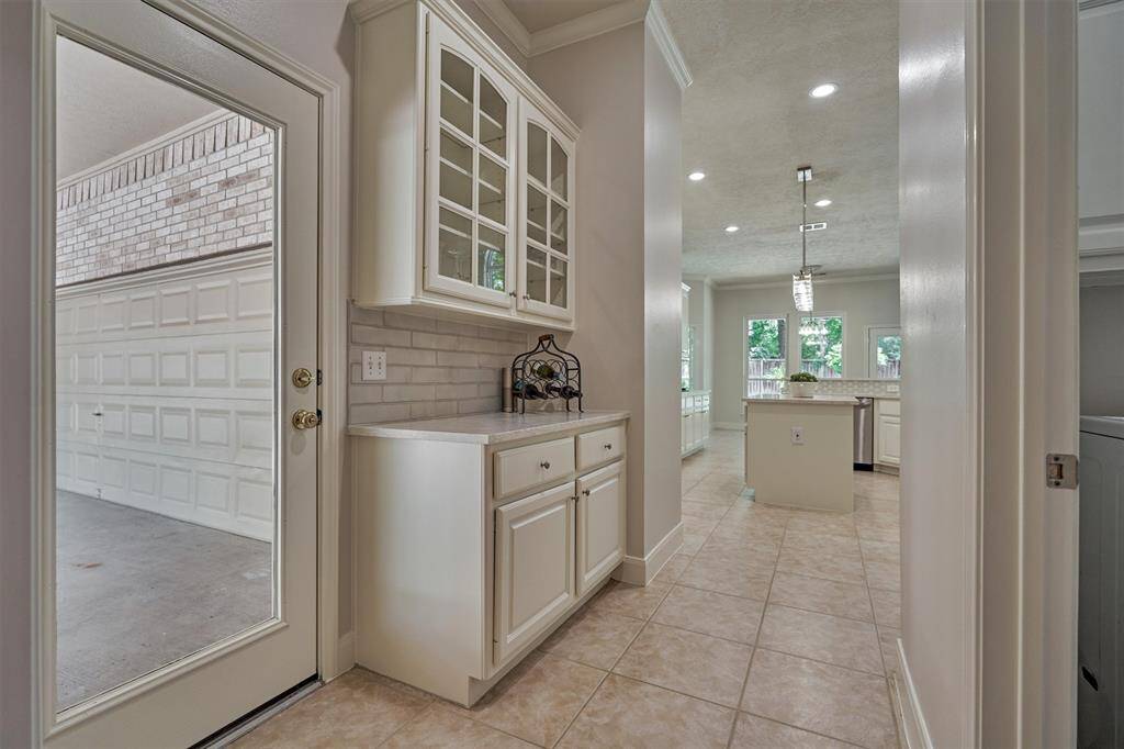 With French doors, a ceiling fan, and unmatched views of the rear grounds, this room can serve many functions - a 2nd home office, craft or music room, downstairs rec room, more!
