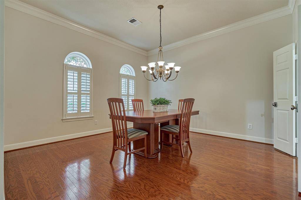 Soaring ceilings and walls of windows elevate the richness of this living area!