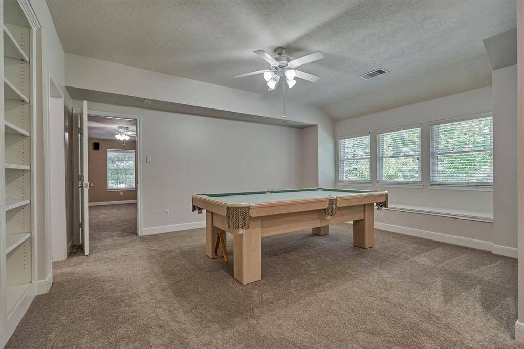 Timeless leisure in this ideally suited game room with built-ins! Pool table is negotiable!